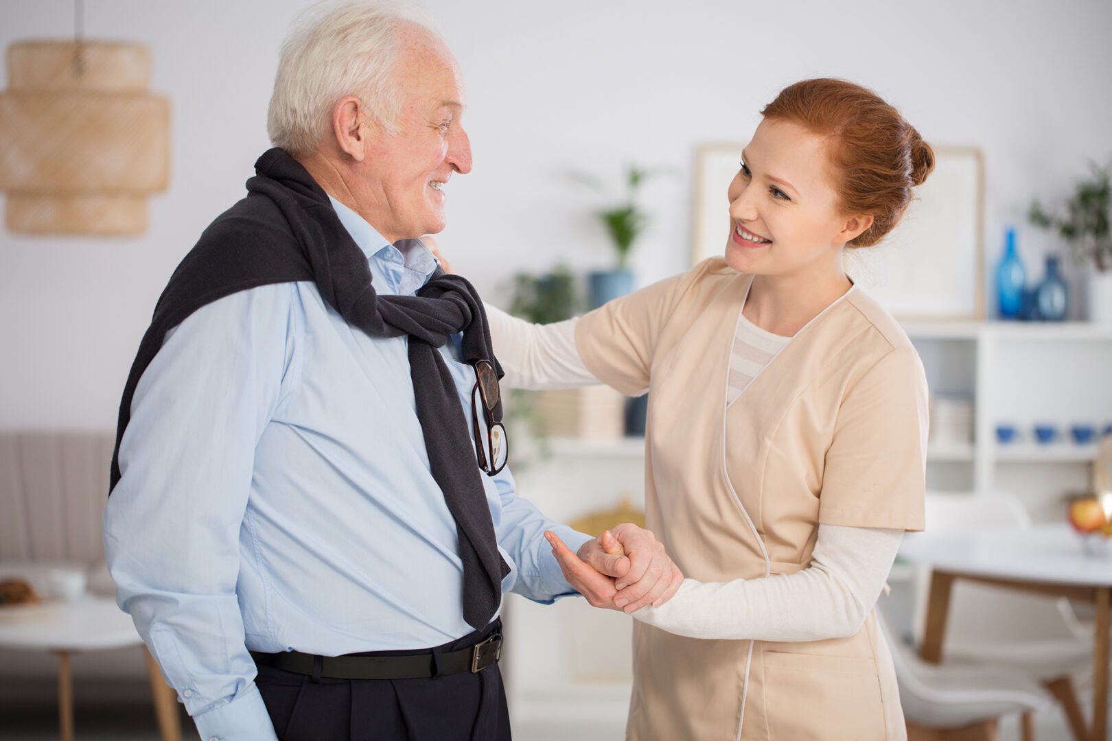 A caregiver helping a senior man