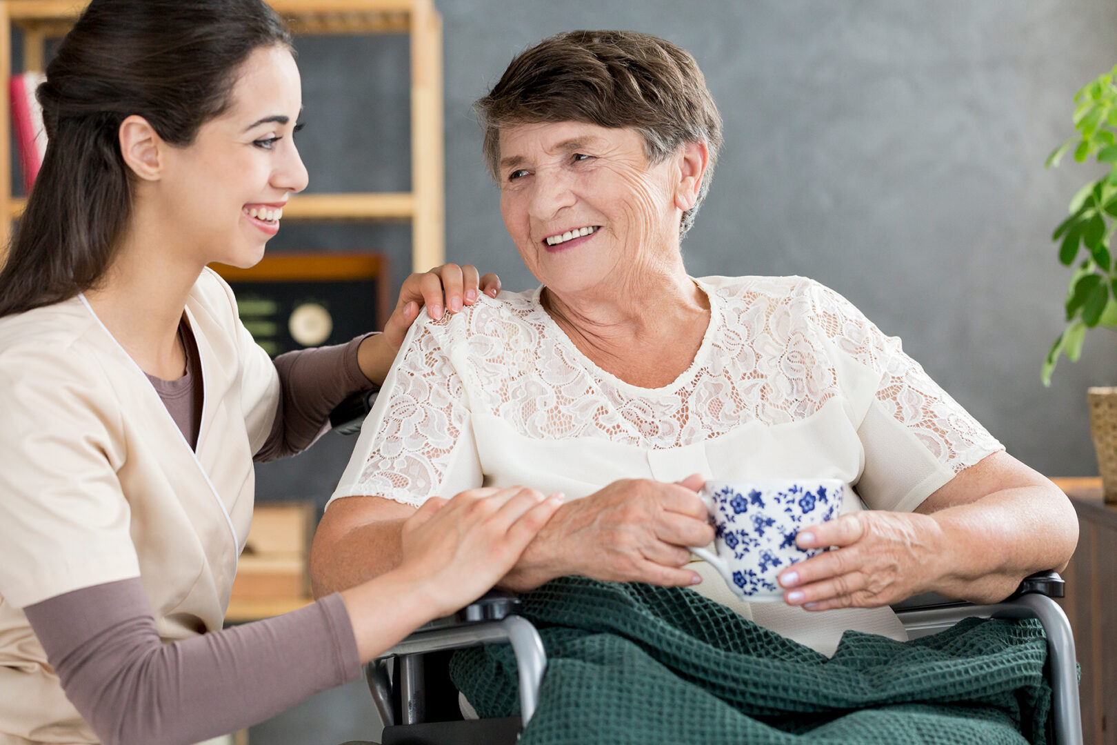 A caregiver with a senior woman talking