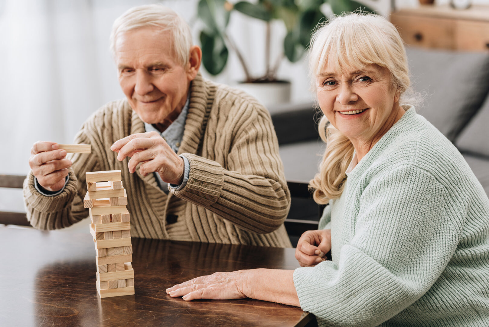 A senior man playing jenga for mental stimulation