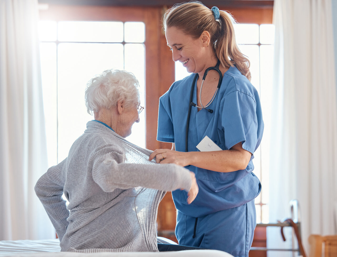 A hard-working caregiver helping a senior woman